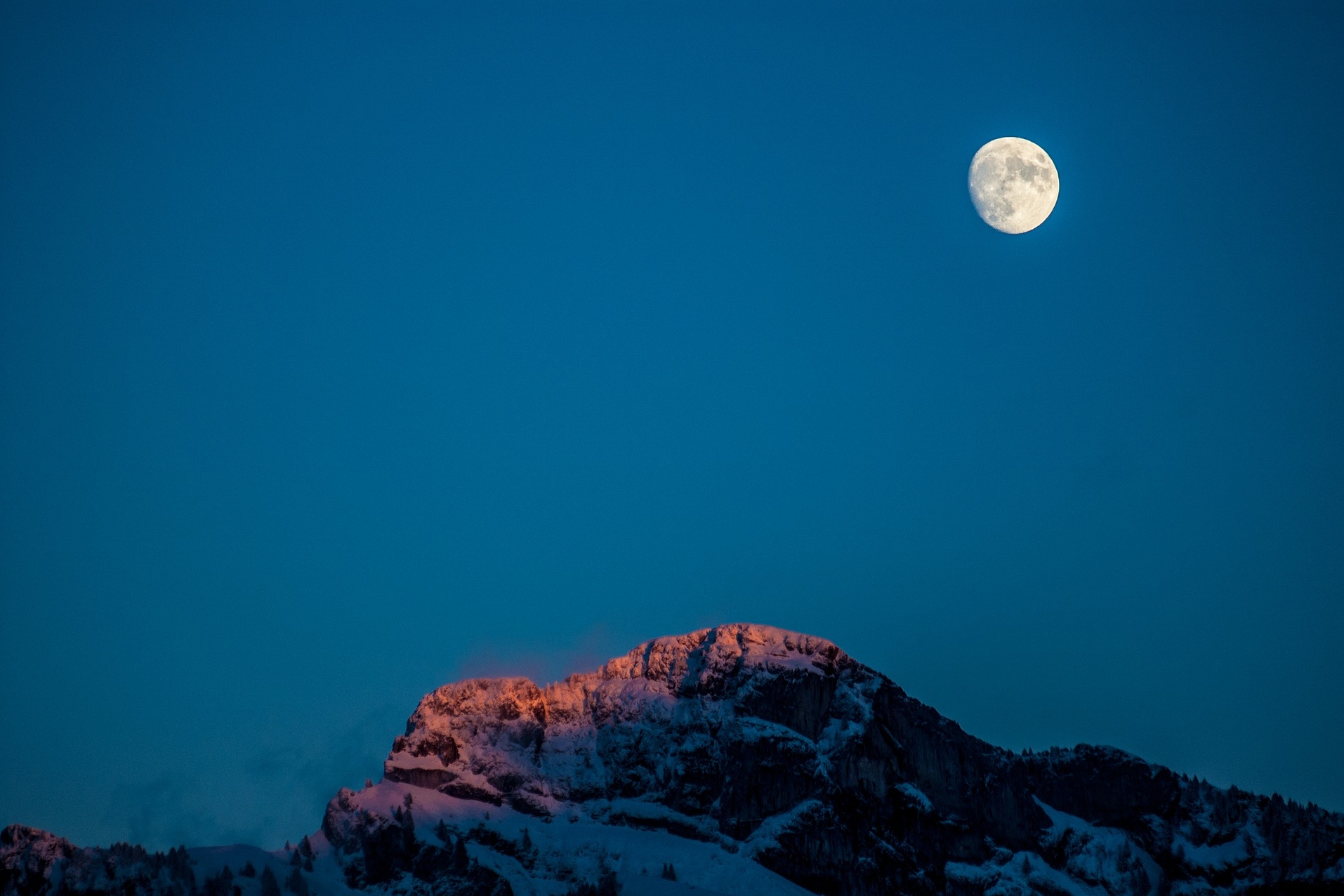 Moon over snowy mountains